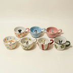 Assorted floral mugs with tiny pet figurines