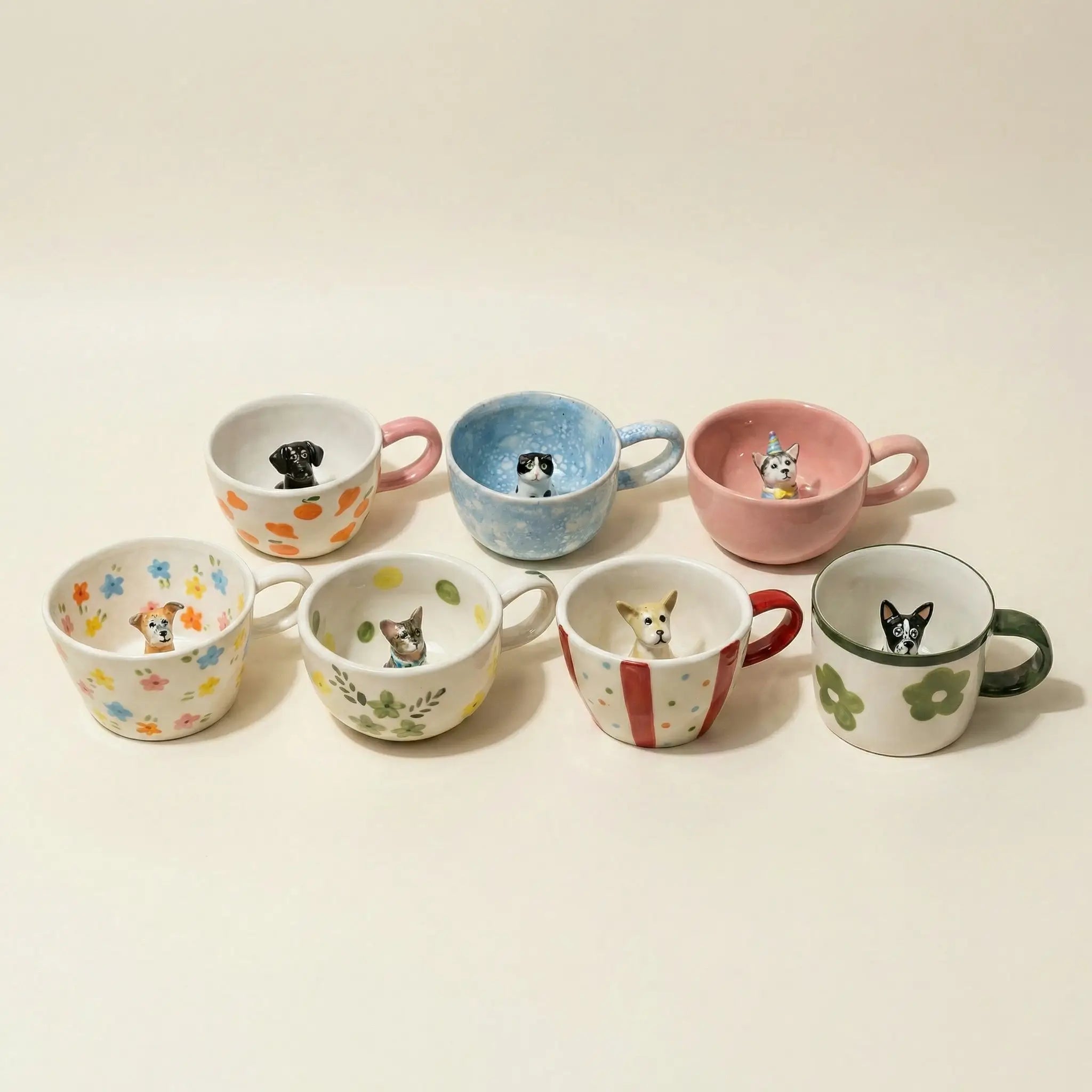 Assorted floral mugs with tiny pet figurines