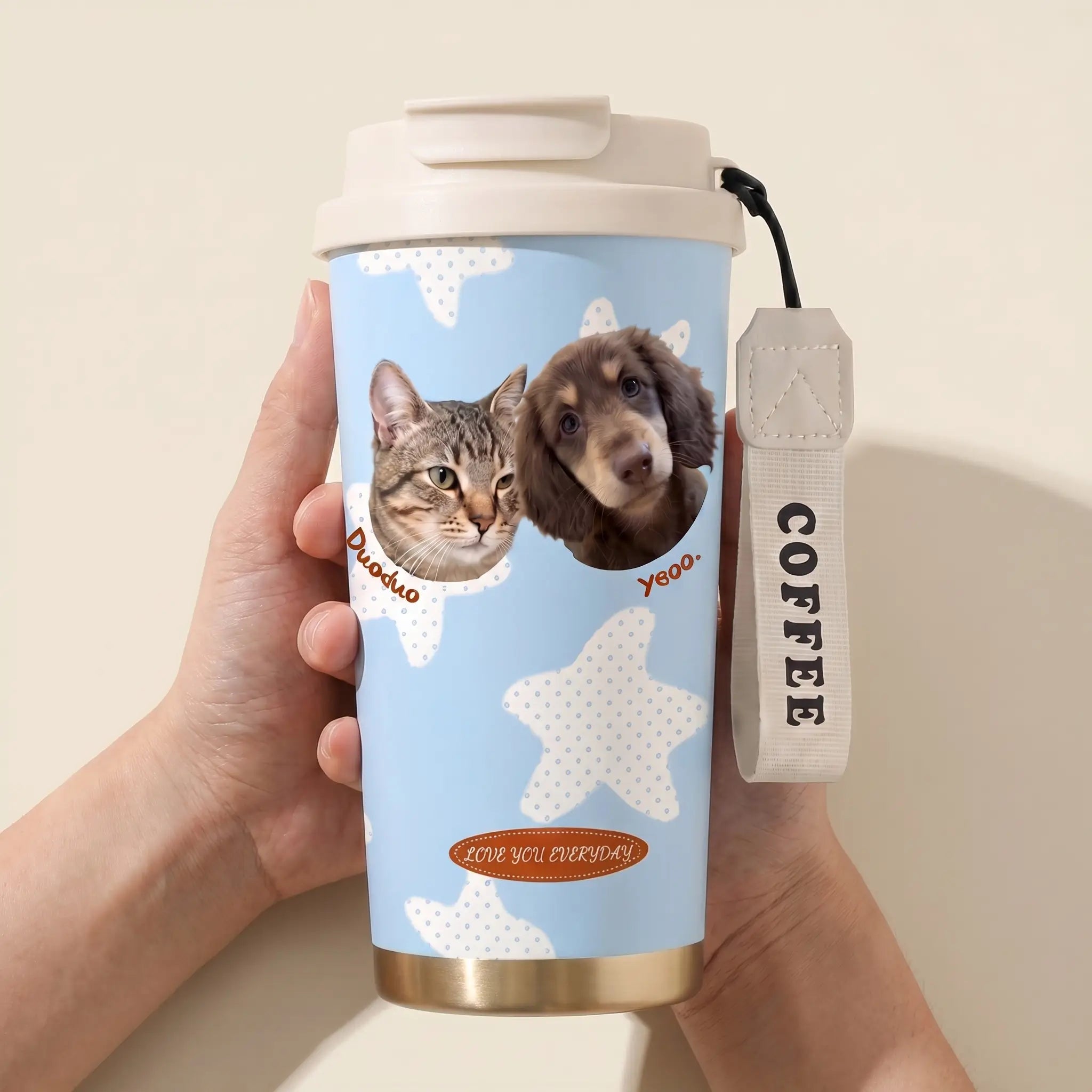 Hand holding reusable pet portrait coffee cup