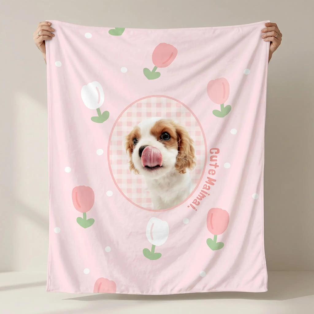 Hands holding pink dog flannel blanket