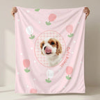 Hands holding pink dog flannel blanket