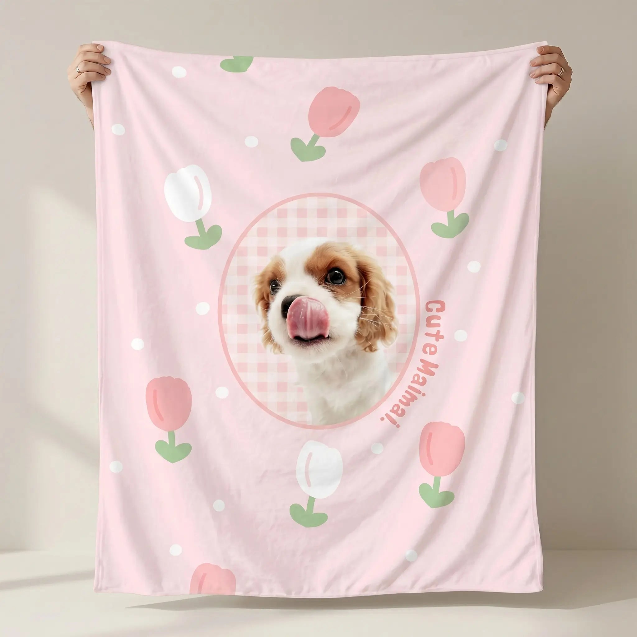Hands holding pink dog flannel blanket
