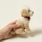 Hand holding realistic dog clone sculpture