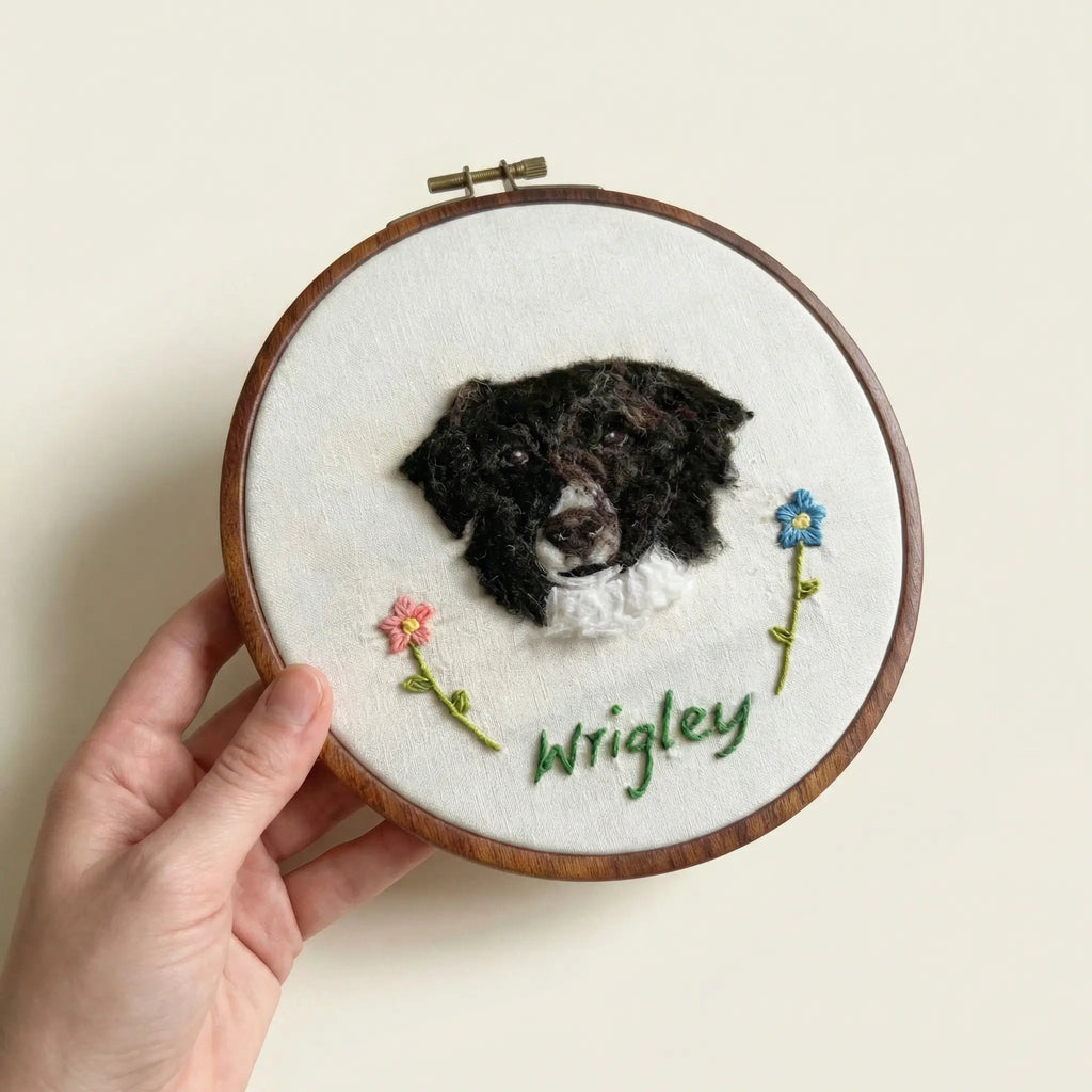 Hand holding wool felt dog portrait hoop
