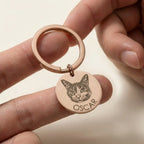 Hand holding round pet portrait keychain