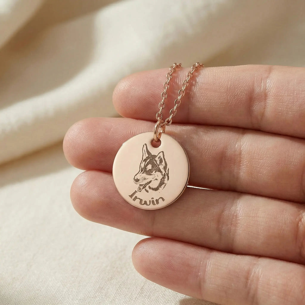 Hand holding round pet portrait necklace